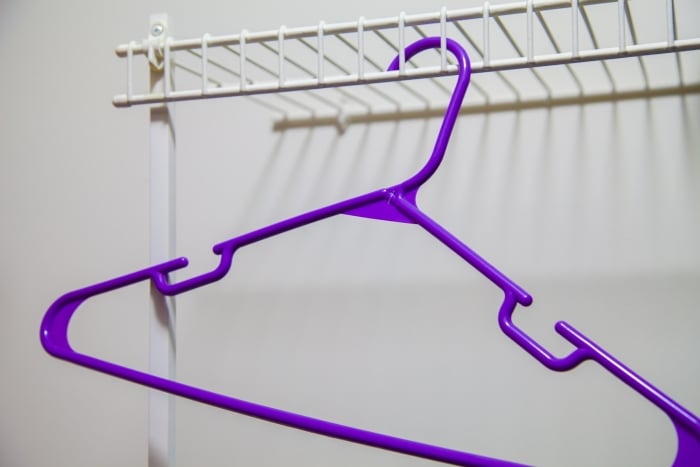 A hanger in an empty closet